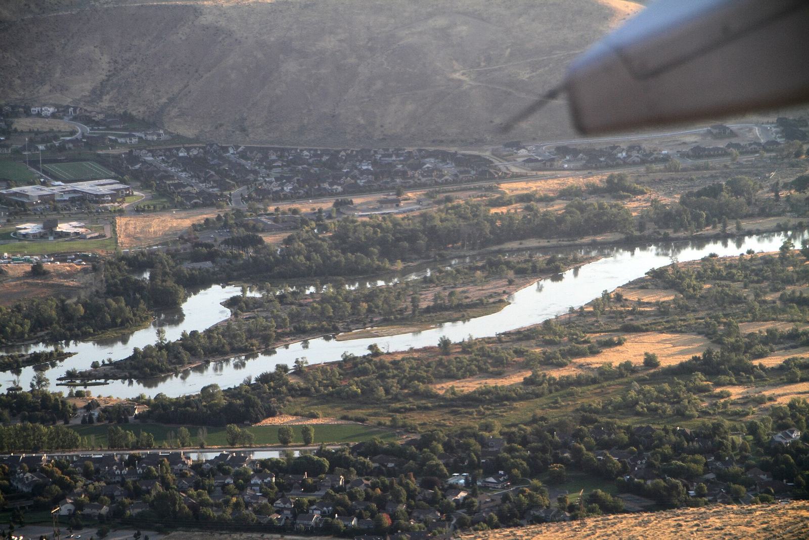 The Boise River and Greenbelt path lined with trees in Boise, Idaho